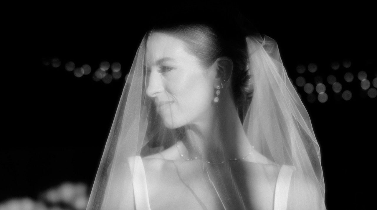 A bride in a veil, photographed in the evening